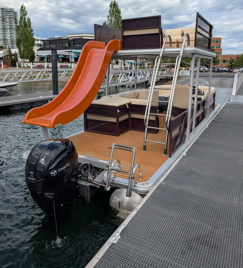 Orange water slide running from the upper deck into Okanagan Lake